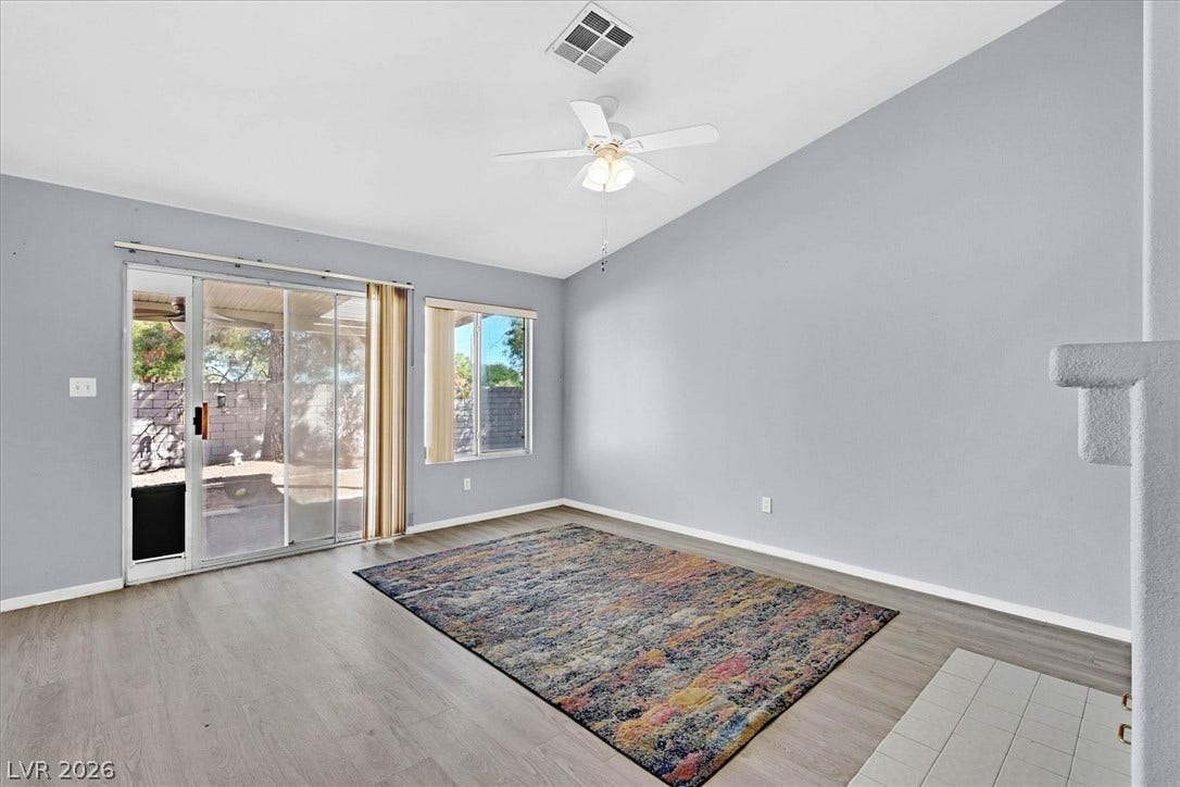 8830 Haviland Road, Las Vegas, NV 89123 Sliding glass doors open to the patio from this spacious living area with durable flooring.
