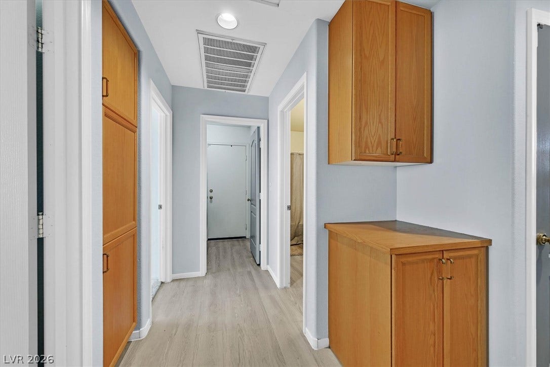 8830 Haviland Road, Las Vegas, NV 89123 Built-in wooden cabinetry provides abundance of storage space throughout this central hallway.