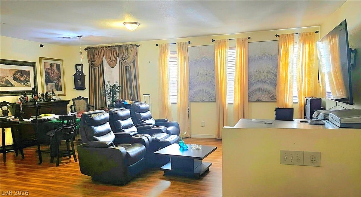 5087 Caprock Canyon Avenue, Las Vegas, NV 89139 Rich wood-look flooring and multiple windows define this versatile living space.