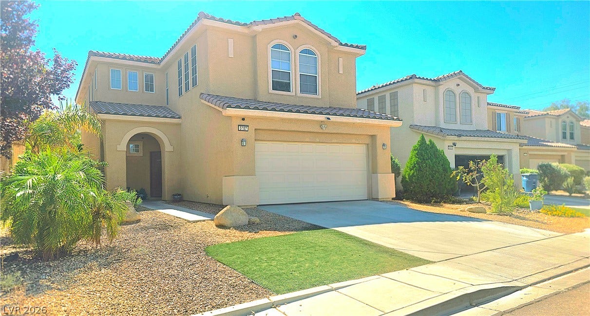 5087 Caprock Canyon Avenue, Las Vegas, NV 89139 Spanish tile roofing and an arched entryway define the classic exterior of this two-story residence.