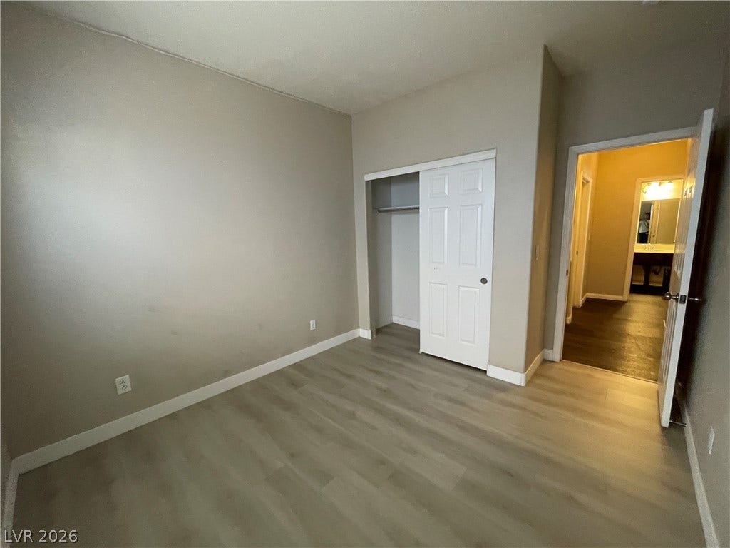7873 Blue Brook Drive, Las Vegas, NV 89147 Smooth wood-style flooring runs throughout this versatile room featuring a built-in closet.