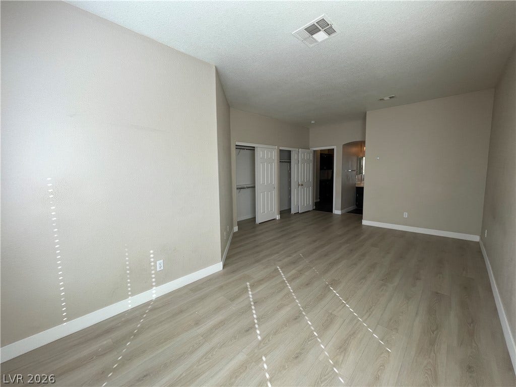 7873 Blue Brook Drive, Las Vegas, NV 89147 Smooth wood-style flooring and dual closets maximize functionality in this spacious bedroom suite.