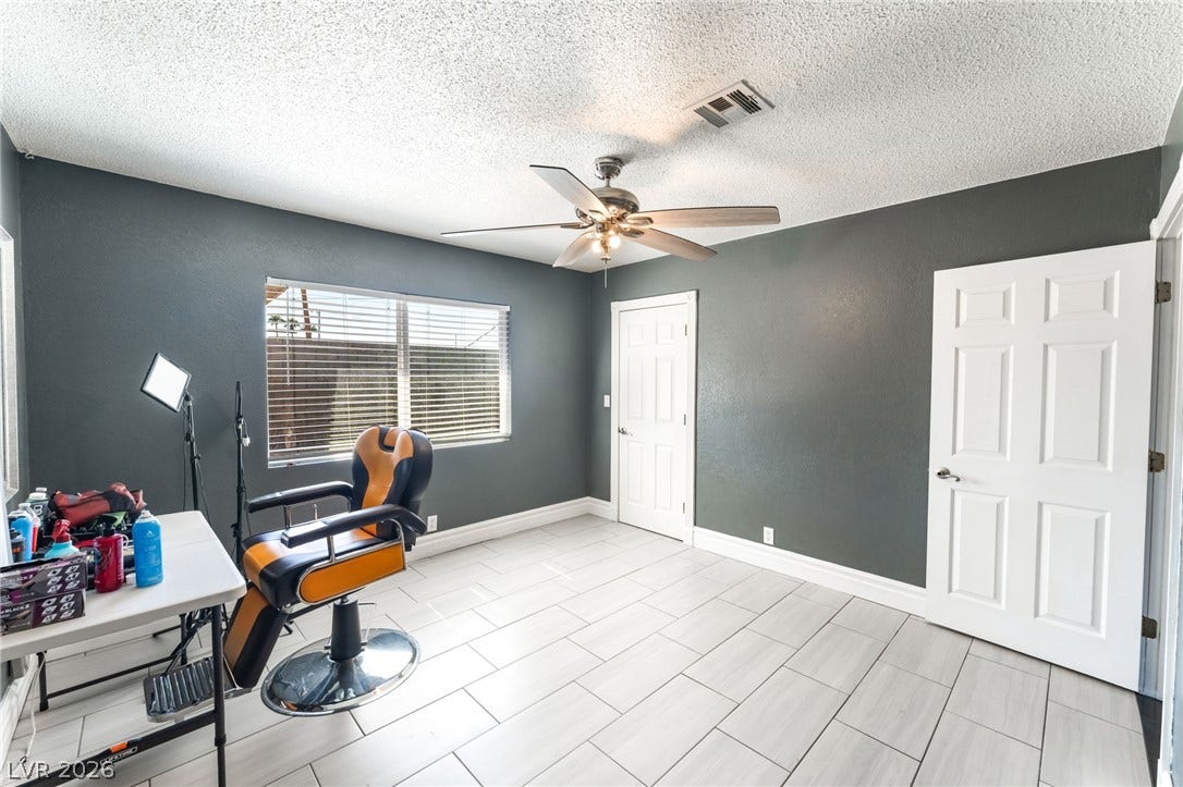 Gleaming tile floors run throughout this versatile space highlighted by wide windows.
