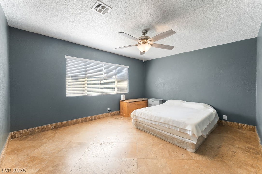 Richly tiled flooring pairs beautifully with smooth, deep-toned walls under a textured ceiling.