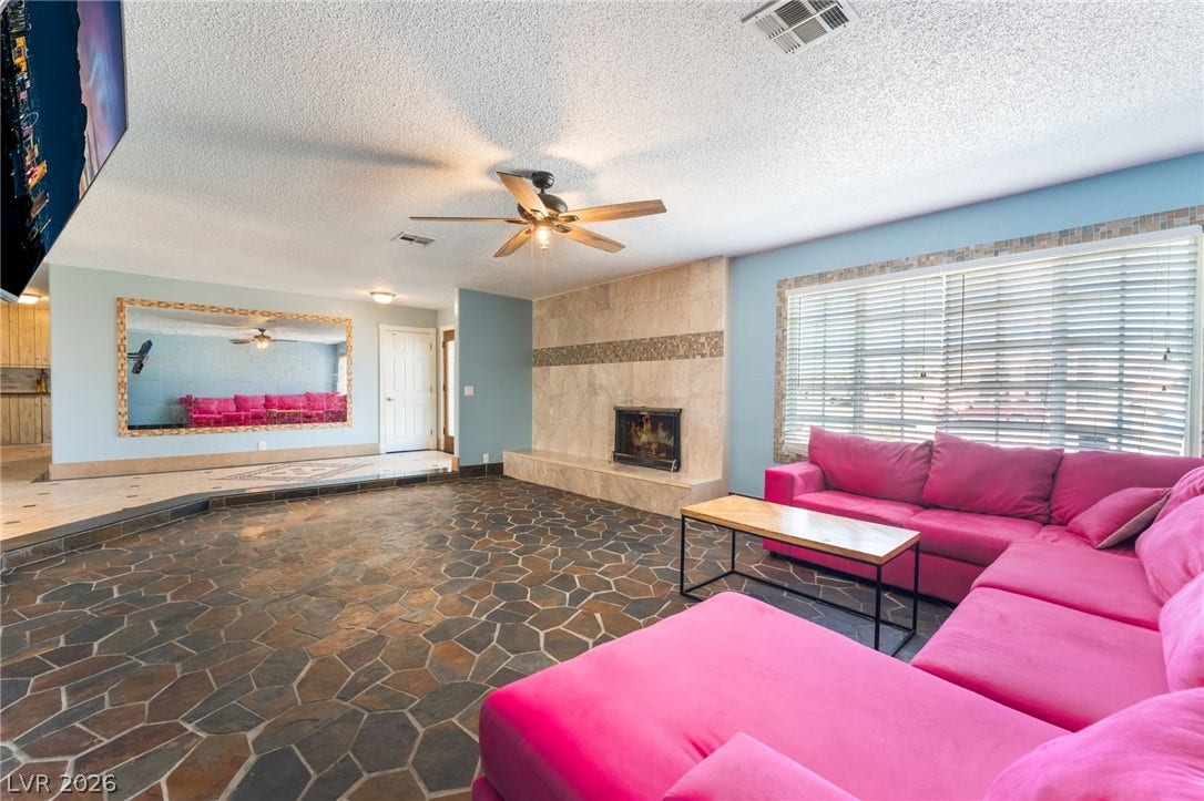 Natural flagstone flooring and a tiled fireplace ground this welcoming interior space.