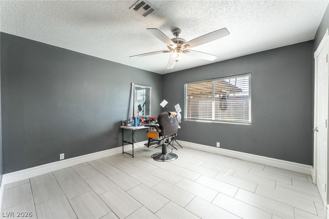 Gleaming tile floors and natural light from a wide window enhance this versatile space.