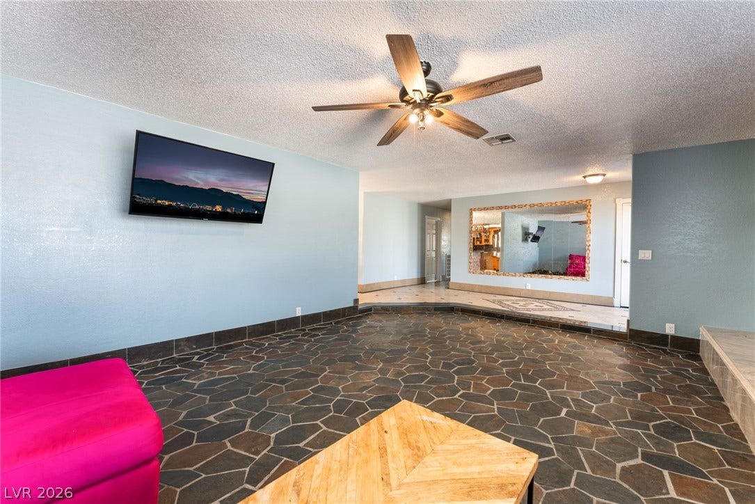 Distinctive flagstone flooring and an open layout define this versatile living space.