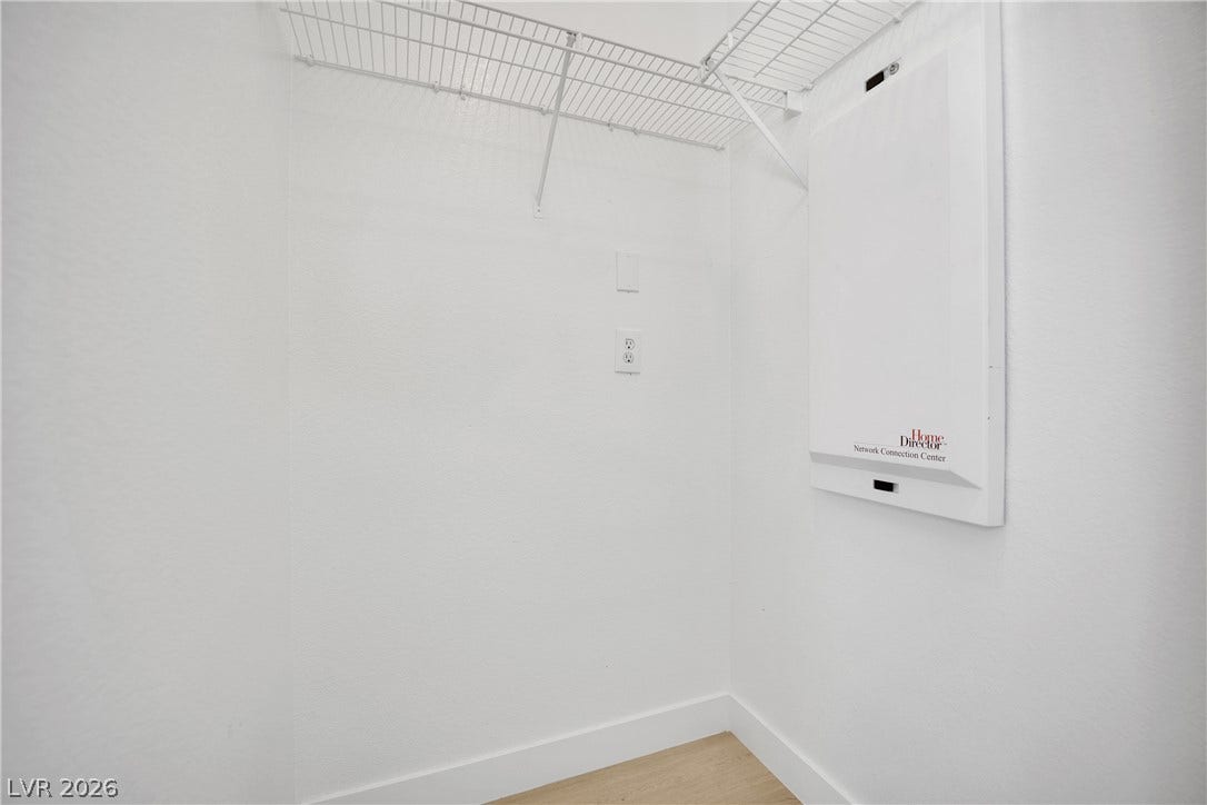 A functional closet provides integrated wire shelving and dedicated network connections for added convenience.