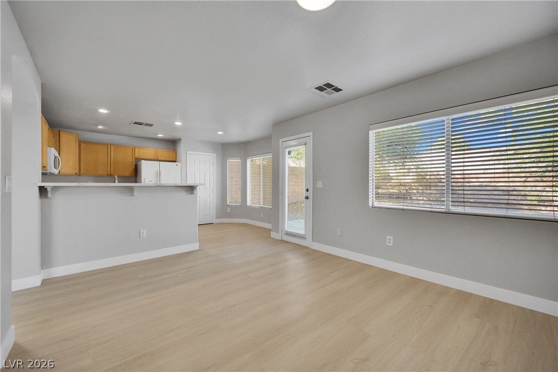 Clean lines and smooth flooring define this light-filled, open living area.