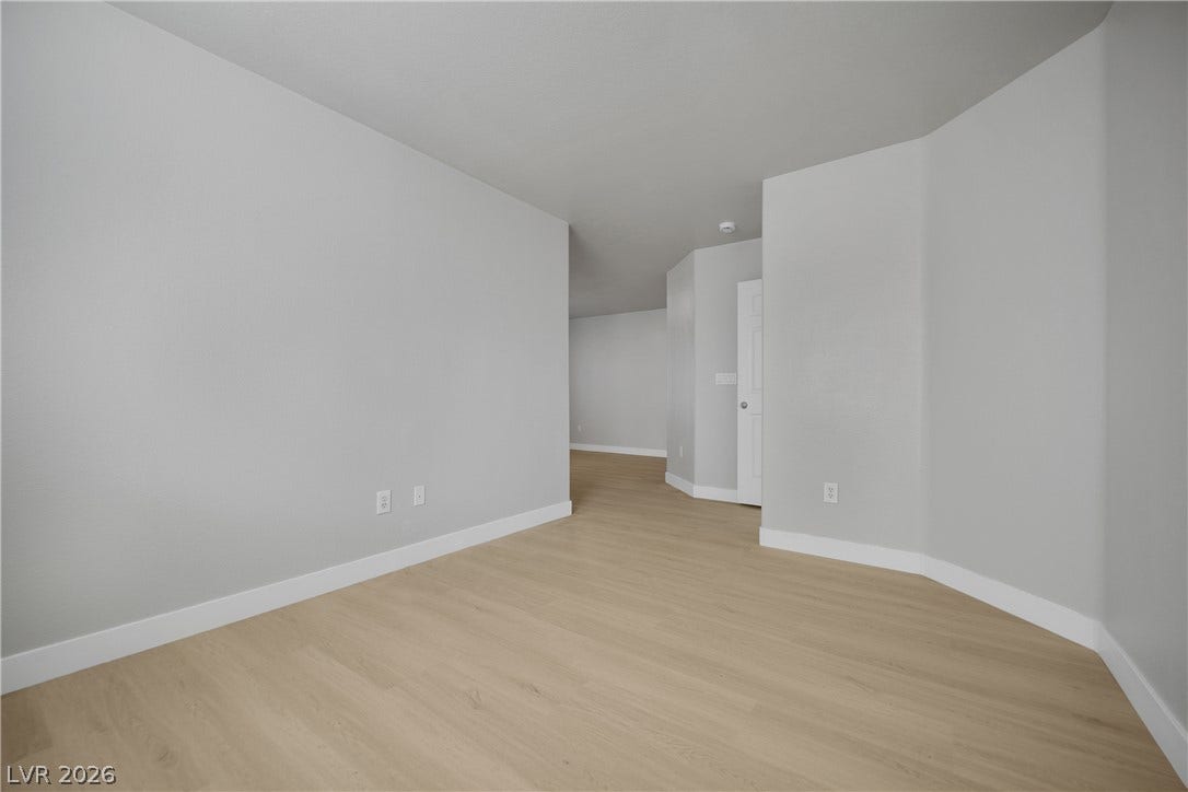 Smooth walls and light wood-tone flooring define this versatile interior space.