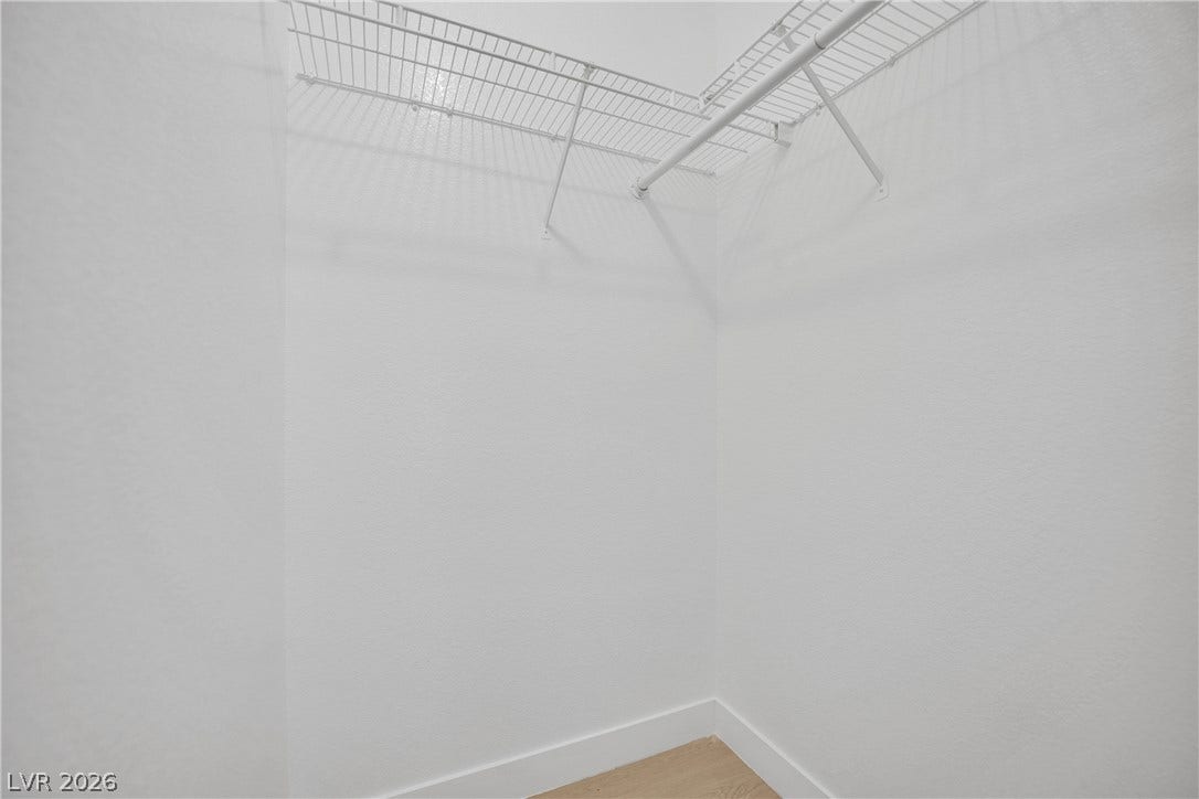 A clean closet offers practical wire shelving above light wood flooring.
