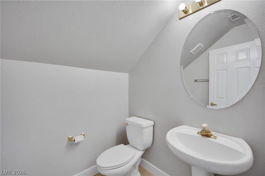 Sloped ceilings bring architectural charm to this cozy half bath.