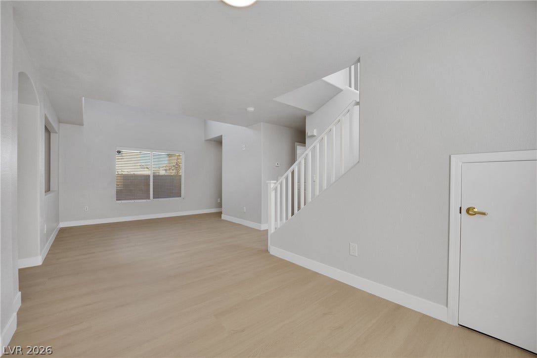 Smooth plaster walls and light plank flooring define this versatile multi-level living area.