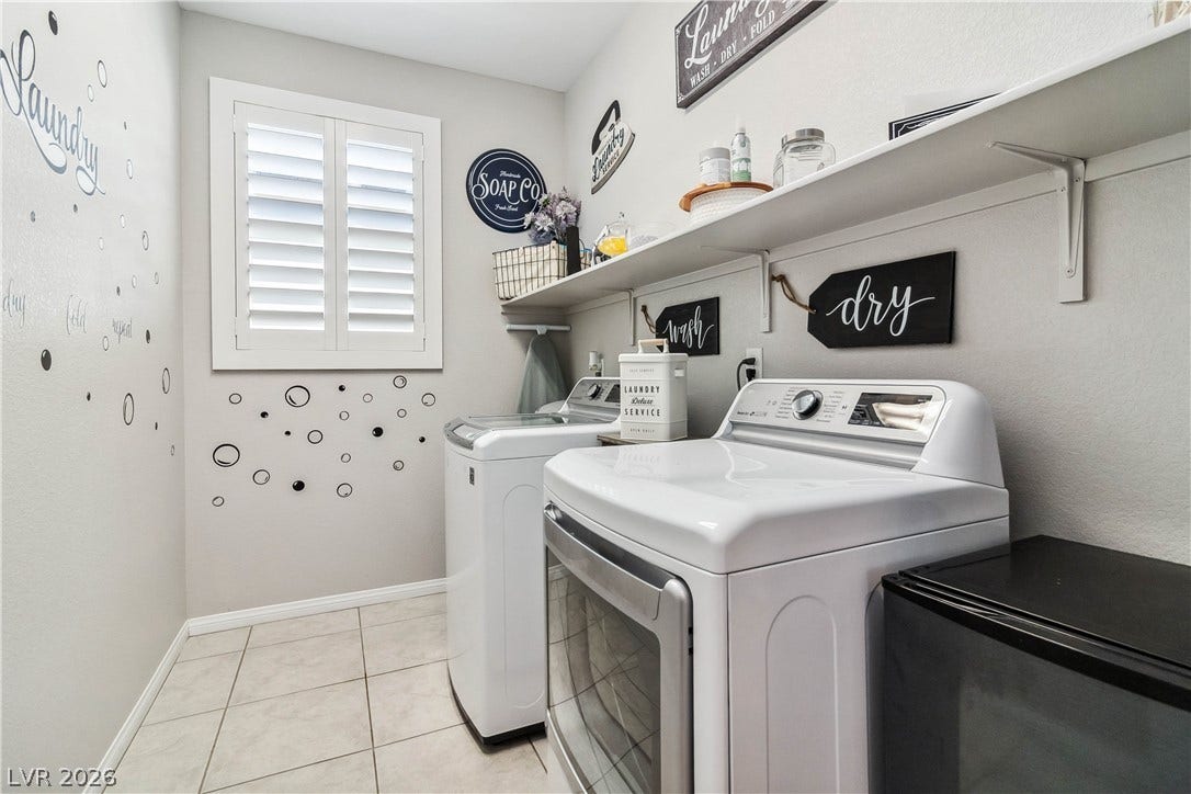 Tiled flooring and built-in shelving maximize organization in this functional utility area.