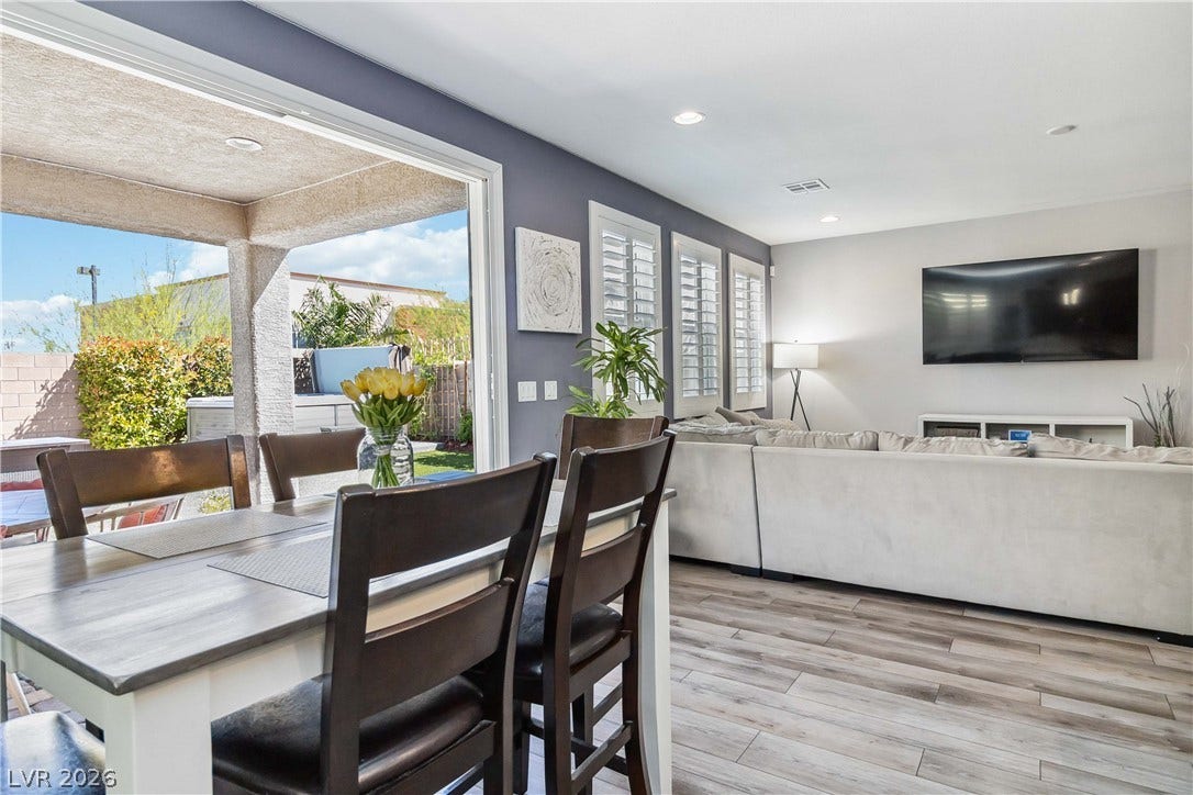 An open-concept living area connects seamlessly to the covered patio through sliding glass doors.