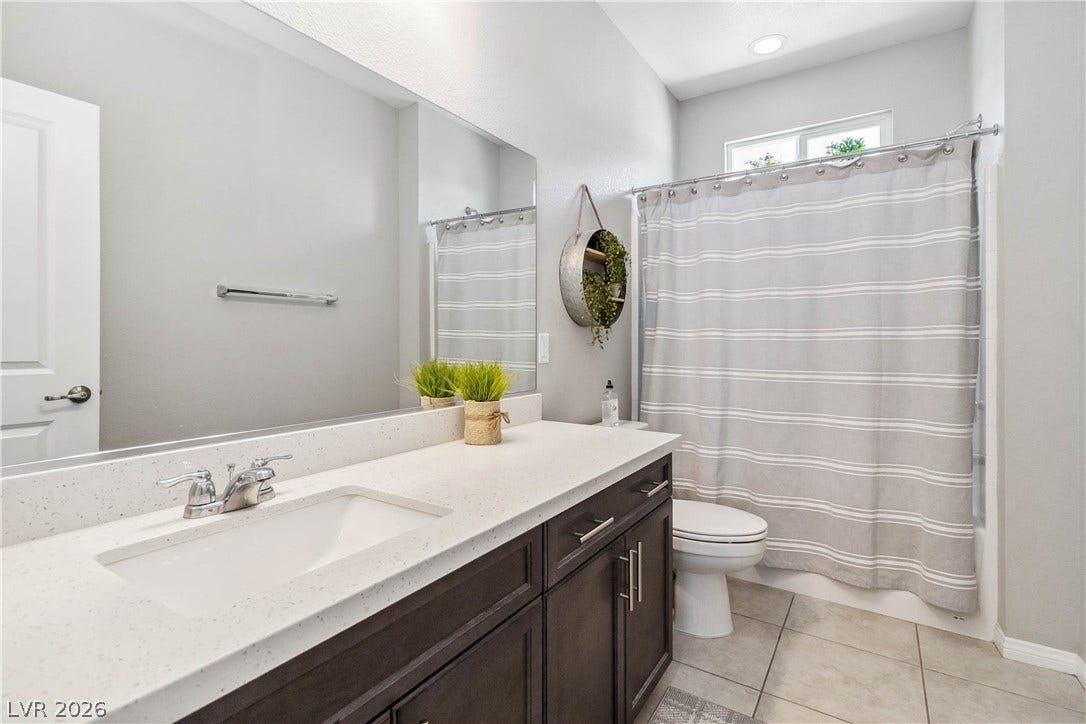 Clean lines and durable stone counters define this modern bathroom space.