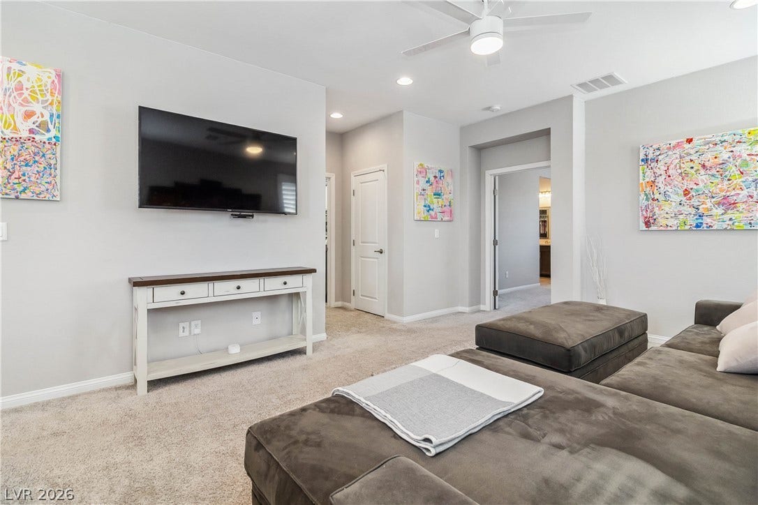 Plush carpeting and soft neutral walls frame a comfortable second-floor living space.