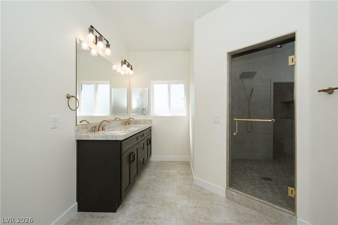 Clean lines and a spacious walk-in shower define this modern primary bath.