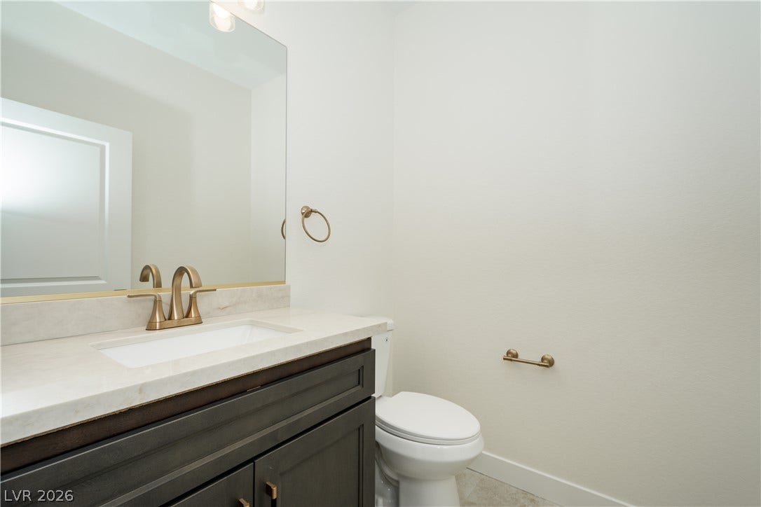 Clean lines and a stone-topped vanity define this modern powder room.