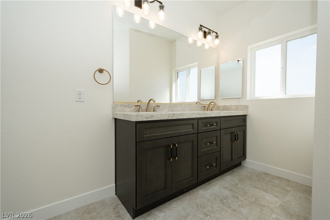 Clean lines and a spacious dual vanity define this elegant contemporary bathroom.