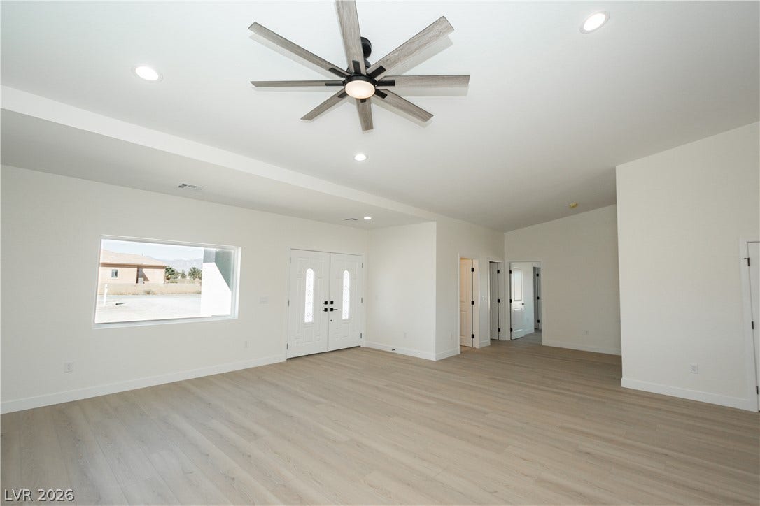 Clean lines and smooth flooring define this spacious, light-filled entryway and living space.