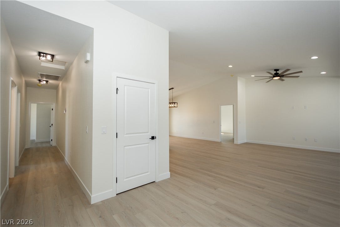 Clean lines and warm wood floors define this airy open-concept living area.