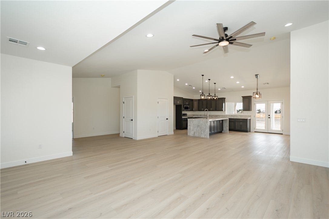 An open concept layout seamlessly connects the spacious living area to the kitchen.