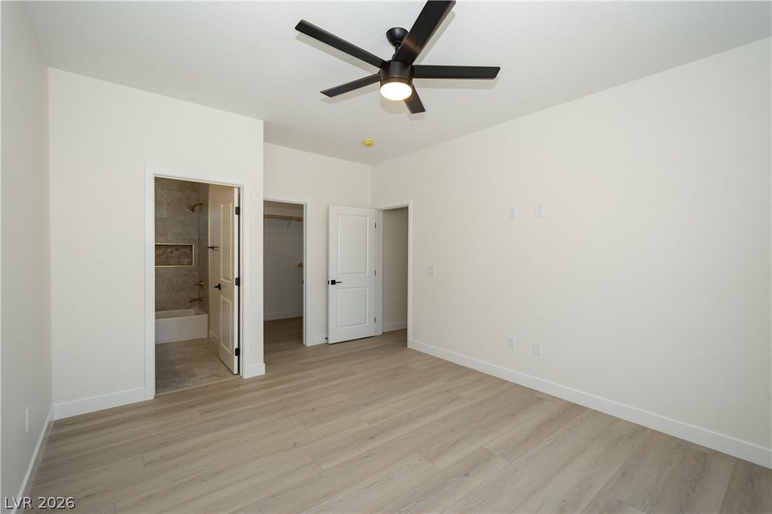 Smooth wood floors flow through this bedroom with direct access to an en-suite bath.