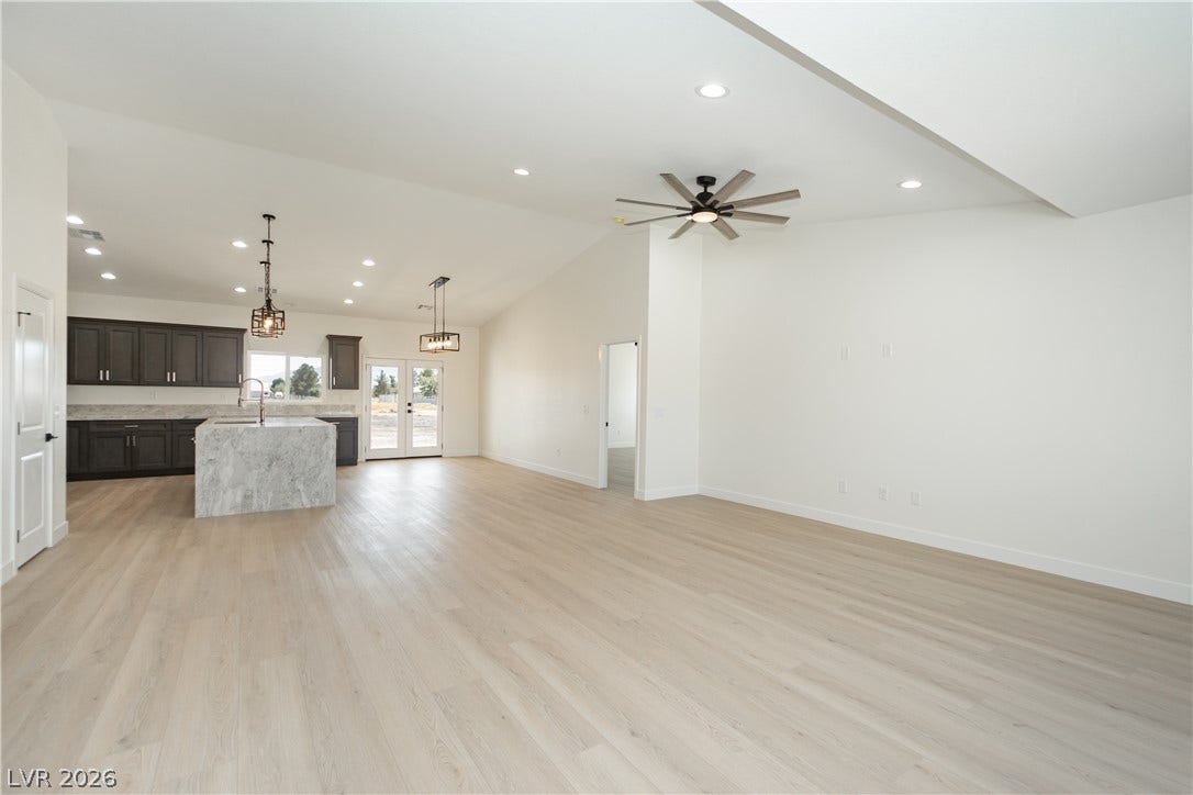 Hardwood floors and vaulted ceilings define this airy, open-concept living space and kitchen.