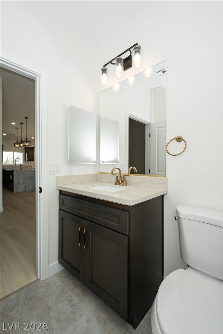 Clean lines and stone counters highlight this contemporary bathroom vanity.