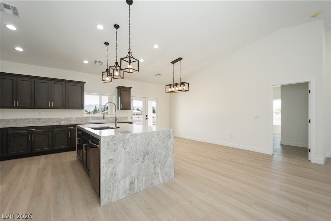 An open floorplan connects the modern kitchen island to the adjacent dining area.