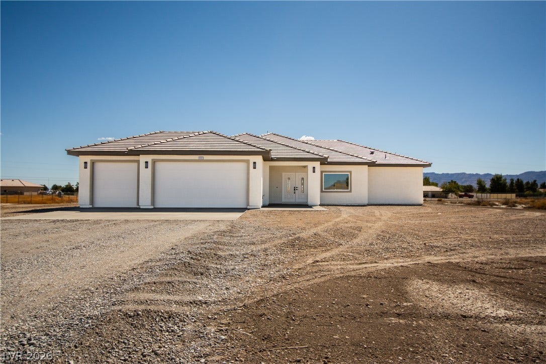 Clean lines and a spacious three-car garage define this newly constructed desert residence.