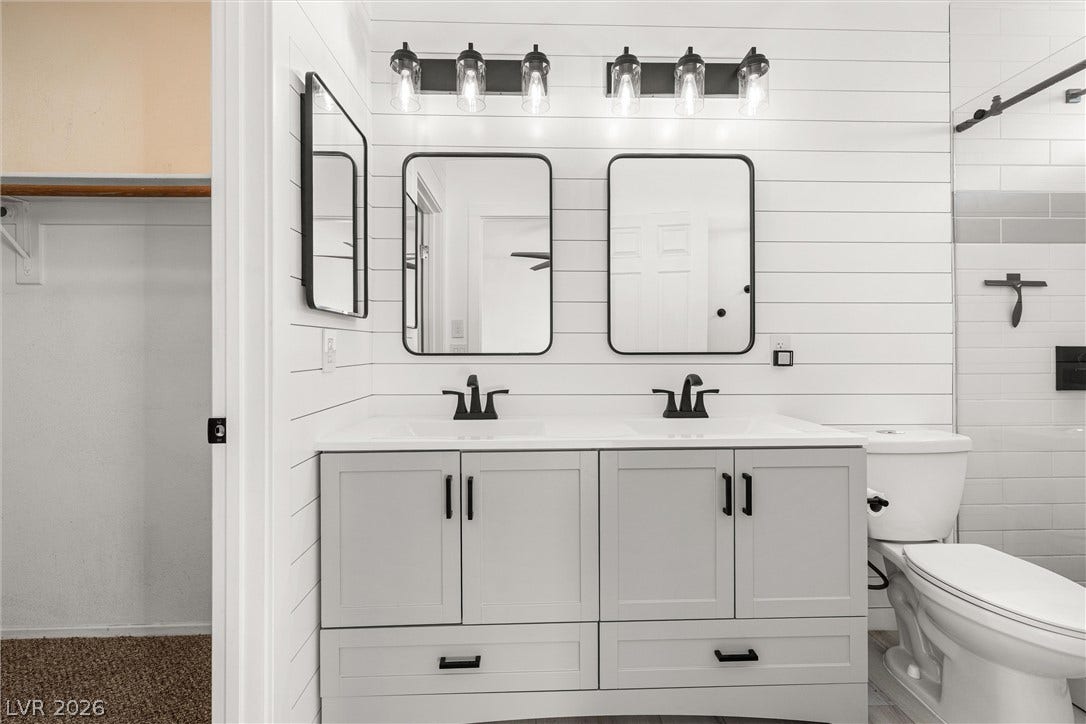 4817 Whispering Spring Avenue, Las Vegas, NV 89131 Clean lines and a double vanity define this modern bathroom with classic shiplap walls.