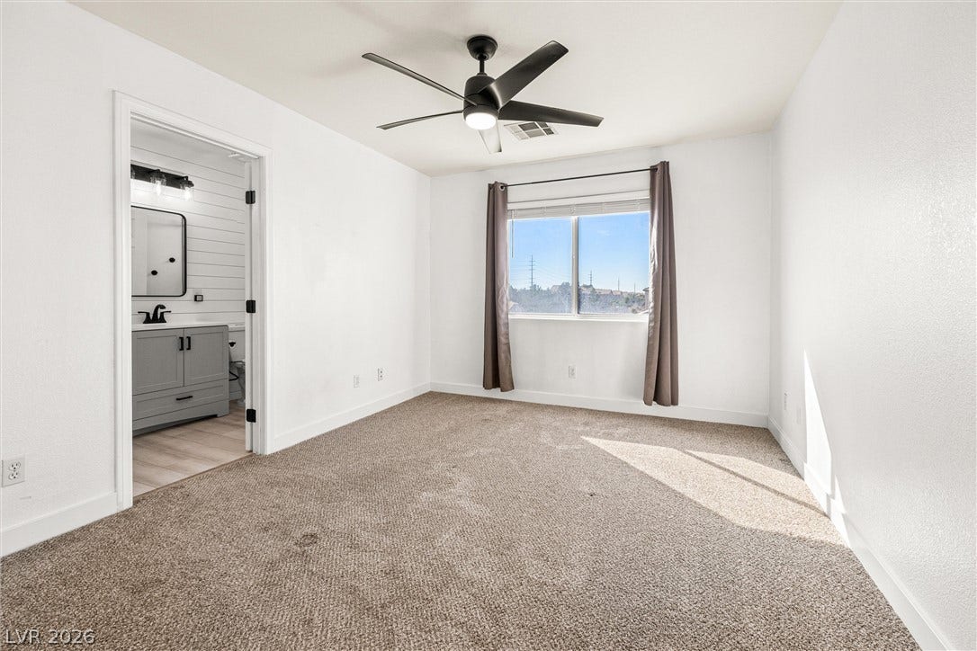 4817 Whispering Spring Avenue, Las Vegas, NV 89131 Plentiful natural light streams across plush carpeting in this serene bedroom with adjoining bath.