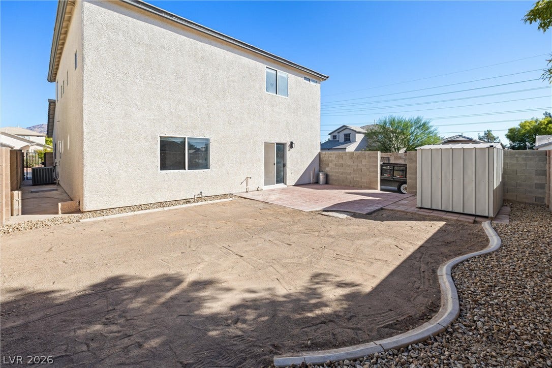 4817 Whispering Spring Avenue, Las Vegas, NV 89131 A spacious backyard area includes a paved patio and a detached storage shed.