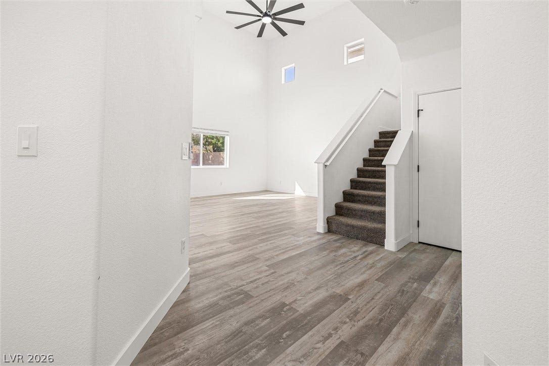 4817 Whispering Spring Avenue, Las Vegas, NV 89131 Soaring ceilings and warm wood-look flooring welcome guests into an airy, light-filled entry.