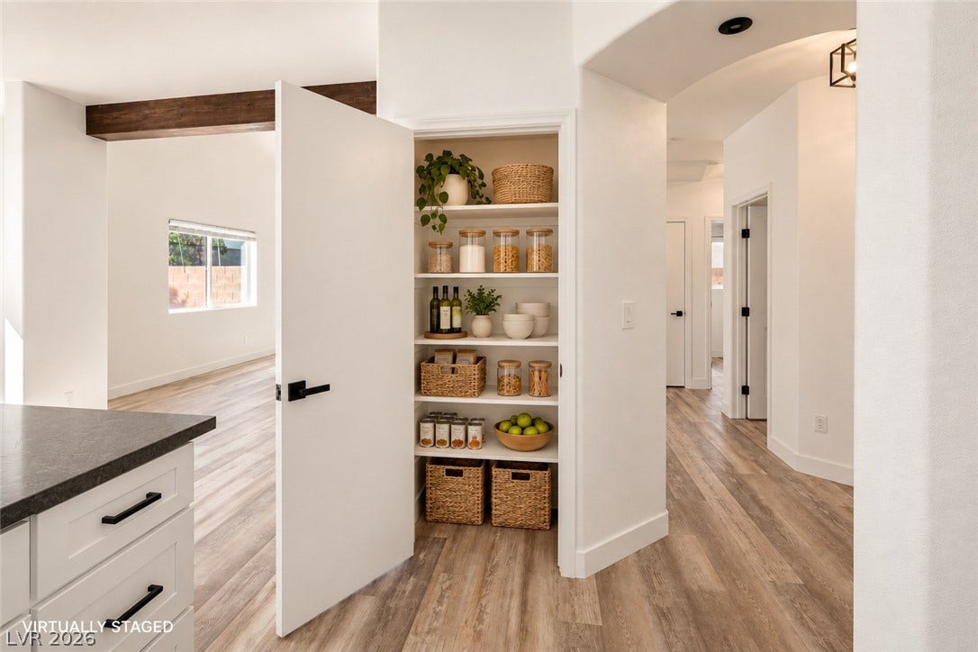 4817 Whispering Spring Avenue, Las Vegas, NV 89131 An organized walk-in pantry provides excellent storage space adjacent to the modern kitchen.