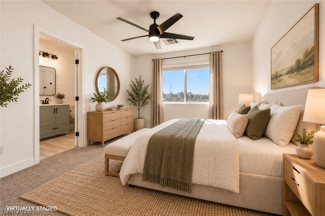 4817 Whispering Spring Avenue, Las Vegas, NV 89131 A spacious bedroom features soft carpet and direct access to an en-suite bathroom.
