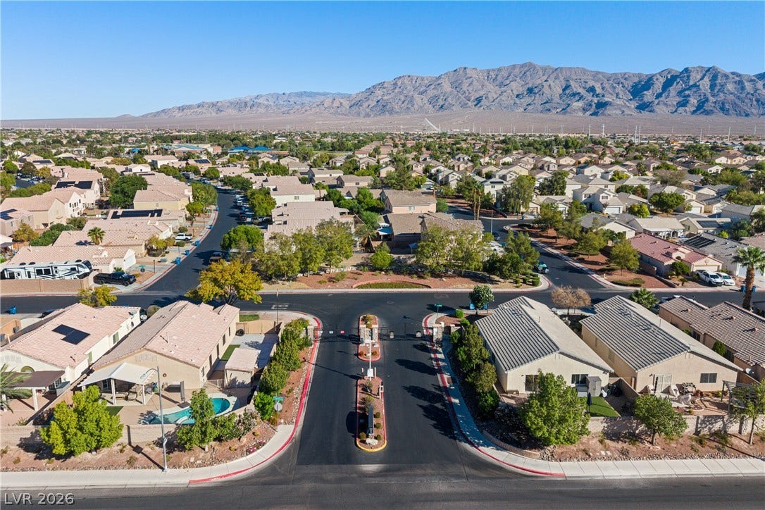 4817 Whispering Spring Avenue, Las Vegas, NV 89131 Gated neighborhood entrance frames this desert community backed by dramatic mountain views.