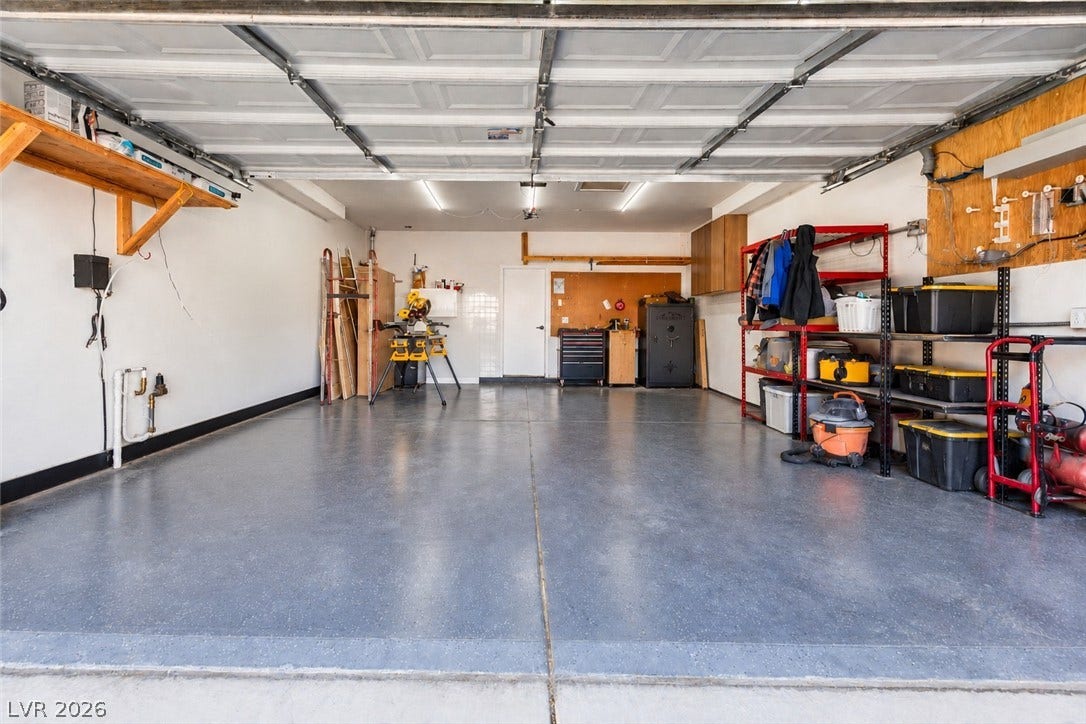 4817 Whispering Spring Avenue, Las Vegas, NV 89131 An expansive garage space features professional flooring and built-in shelving.