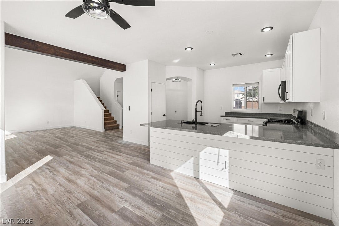 4817 Whispering Spring Avenue, Las Vegas, NV 89131 Gleaming wood-look floors anchor this airy open kitchen and living layout.