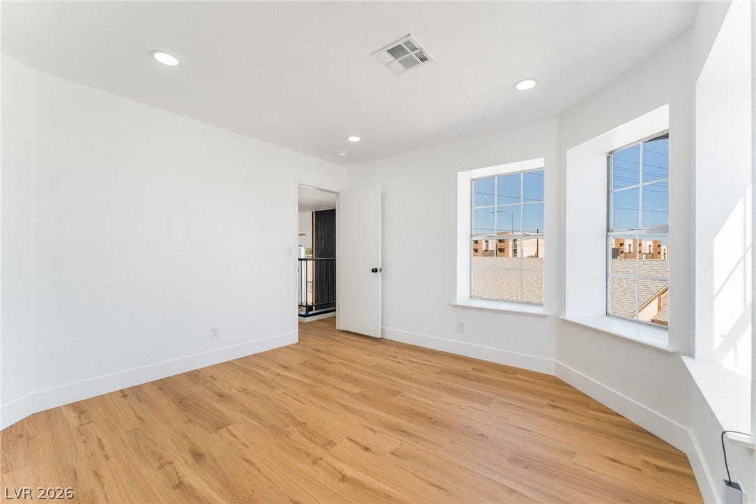 Warm wood flooring and recessed lighting define this inviting, clean-lined space.