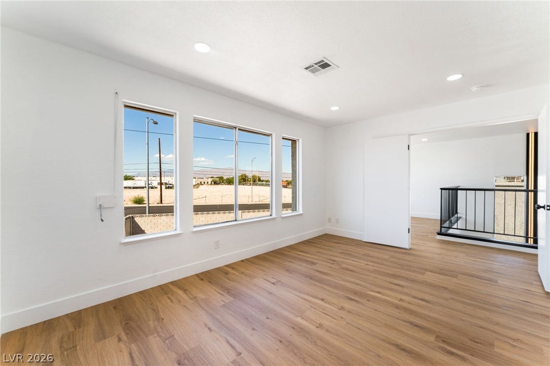 Gleaming wood floors and recessed lighting define this versatile upstairs room.