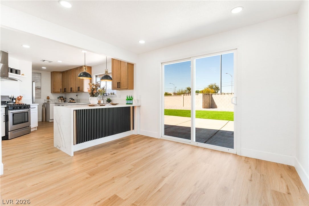 Sliding glass doors connect the bright dining area to the backyard patio.