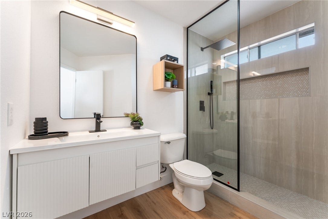 Clean lines and a spacious glass shower define this contemporary bathroom space.