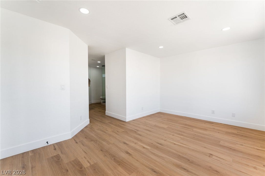 Smooth wood floors and crisp white walls create a clean, modern canvas in this room.