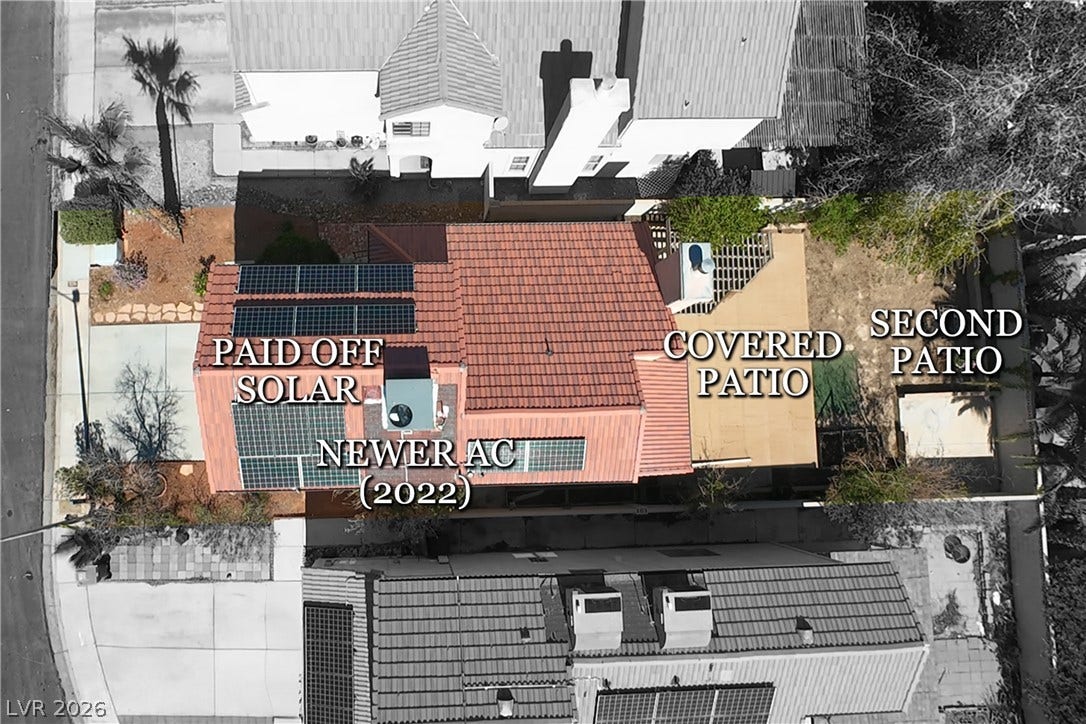 325 Manor Street, Las Vegas, NV 89145 An aerial perspective showcases the tiled roof structure equipped with functional solar panels.