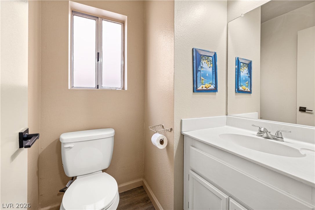 325 Manor Street, Las Vegas, NV 89145 A window brings natural light into this functional bathroom complete with a white vanity.