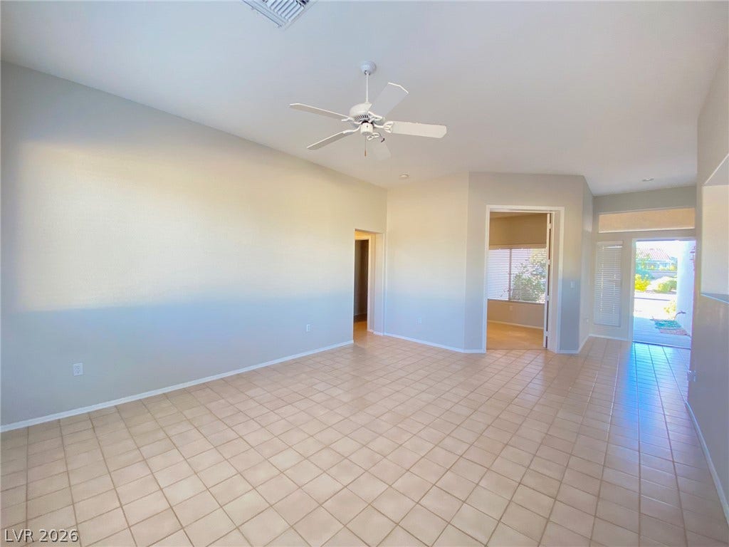 Tiled flooring flows through this airy main room, offering a versatile and easy-care layout.
