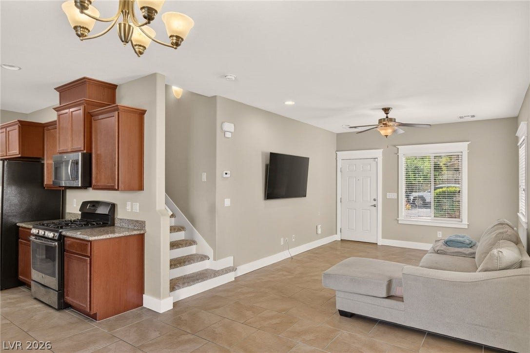 8112 Winterfell Place, Las Vegas, NV 89166 Tile flooring and an open layout connect the kitchen to the comfortable living area.